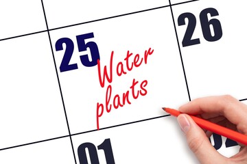 25 th day of the month.  Hand writing Water plants reminder  on calendar with red pen on white background. concept of plant care. Planning and scheduling