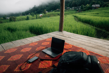 Balcony at the cottage with rice field view and laptop