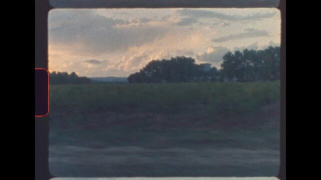 Moving view of French vineyards in Provence captured from a car window at sunset with nostalgic retro film grain and soft analog texture