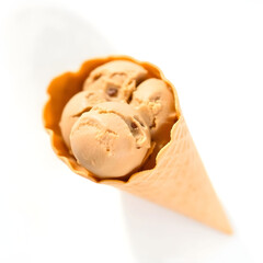 A creamy brown pistachio ice-cream in a crisp waffle cone, placed on a clean and minimalist white background