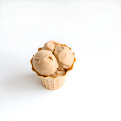 A creamy brown pistachio ice-cream in a crisp waffle cone, placed on a clean and minimalist white background