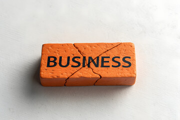 Broken Business Concept with Cracked Brick Symbolizing Failure
