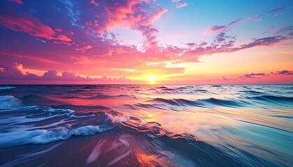 Obraz premium A vivid sunrise over the ocean, reflecting the colorful sky in the water