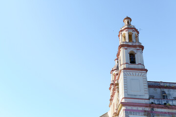 Olvera church bell tower rising against a clear blue sky in olvera,cadiz, spain