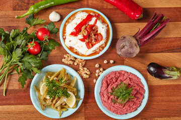 Traditional Turkish Appetizers with Fresh Vegetables – Three Varieties of Meze on Wooden Table