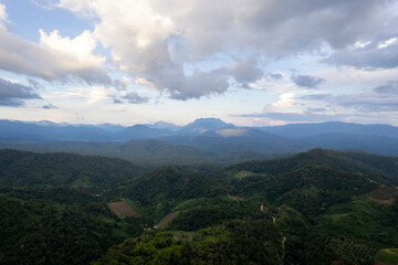 Landscape of Morning Mist with Mountain Layer. mountain ridge and clouds in rural jungle bush forest