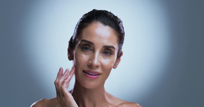 Face, beauty and woman in studio, cosmetics and dermatology on gray background. Space, shine and mature person with skincare, glow or wellness with healthy skin, anti aging or aesthetic with grooming