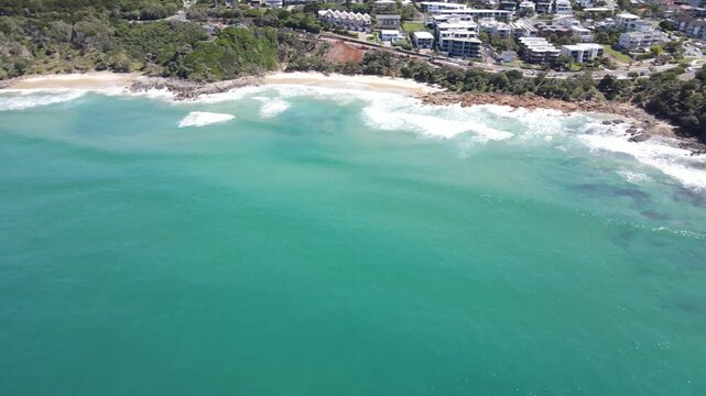 Drone aerial panning over the beautiful blue water of coolum beach in Australia