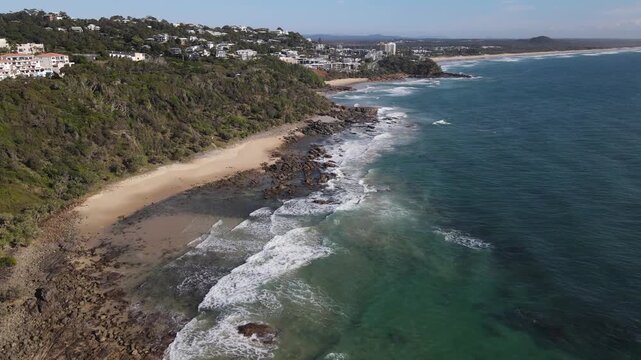 Drone aerial going over an ocean trail in Coolum Beach on a sunny day