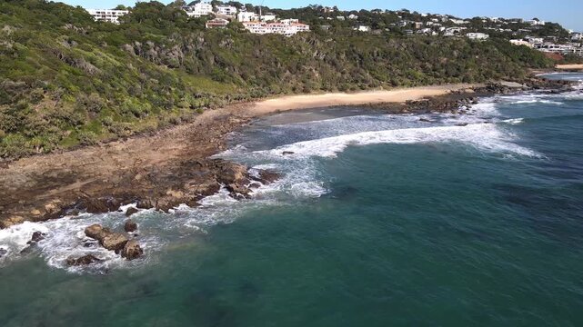 Drone aerial in coolum beach pan down to a pristine beach