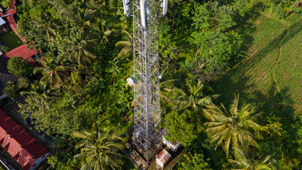 Aerial Photo of Telecommunication Tower in Rural Area Surrounded by Trees and Rice Fields