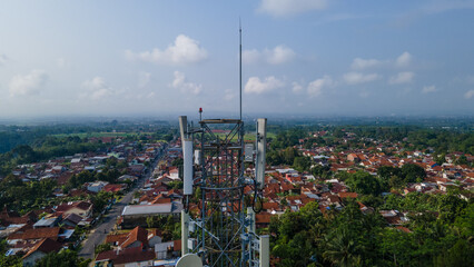 Obraz premium Aerial Photo of Telecommunication Tower in Rural Area Surrounded by Trees and Rice Fields