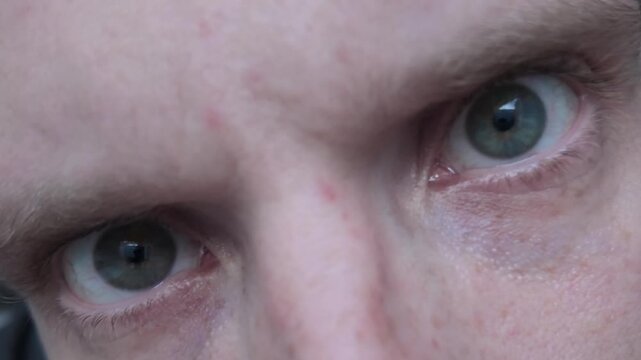 Macro shot of eyes reflecting screen light representing disinformation confusion