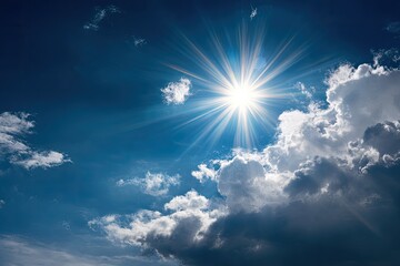 A bright sun shines brightly against a deep blue sky, with dramatic, fluffy clouds