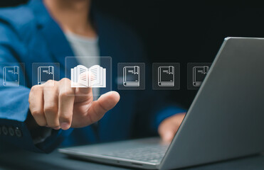 E-library concept. Businessman focus to virtual Ebook icons for electronic books online, knowledge base on internet, digital library or e-library.