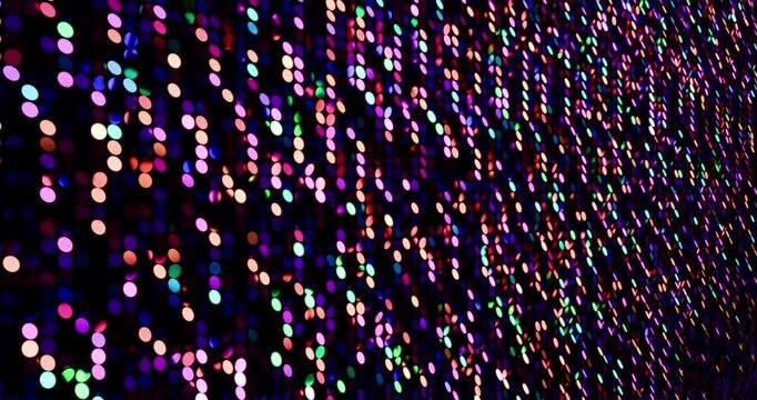 Multicolor sequins turn up in a random pattern. Side macro view of gorgeous waving pattern background. 4K 3D rendering loop animation.