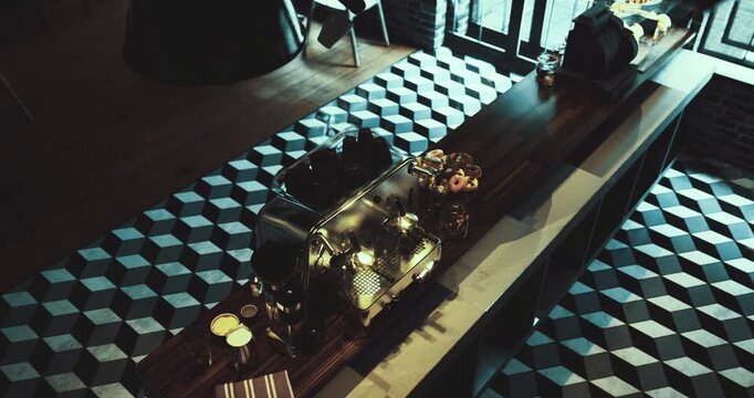 A coffee shop showcases a sleek counter with espresso machines and an array of pastries. The geometric floor adds visual interest to the cozy, inviting atmosphere.