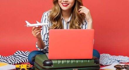 Bright Stylish Woman Planning Trip with Laptop and Airplane Model
