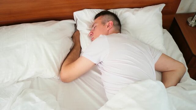 Caucasian man wake up sleeply in bed