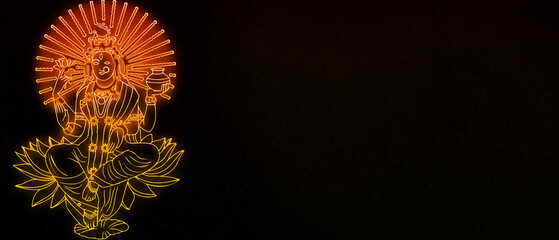 radiant neon outline of Goddess Lakshmi seated on a lotus, with a glowing sunburst halo, in orange and yellow tones against a dark background