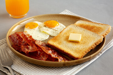 Homemade American Bacon Egg and Toast Breakfast on a Plate, side view.