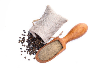 Black peppercorns and ground black pepper powder on white background	