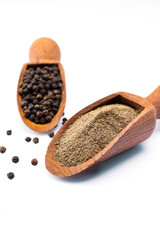 Black peppercorns and ground black pepper powder on white background	