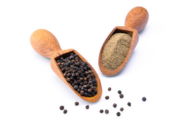 Black peppercorns and ground black pepper powder on white background	