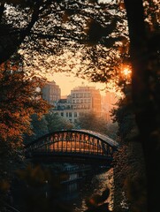 A serene urban scene with a metal arch bridge over a calm river surrounded by trees during golden hour with the sun setting behind city buildings
