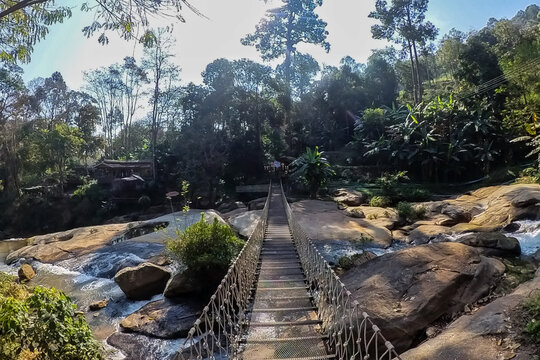 Fototapeta Rope bridge over the waterfall