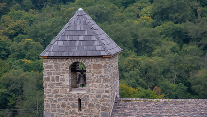Fototapeta premium Historic Stone Bell Tower Overlooking Scenic Forest