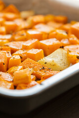 tray with roasted pumpkin butternut squash onion and garlic close up