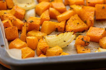 tray with roasted pumpkin butternut squash onion and garlic close up