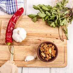 Fresh ingredients on a wooden cutting board, ready for cooking.