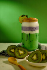 Refreshing summer beverage made from kiwi and taro, served chilled with mint leaf and lime slice.
