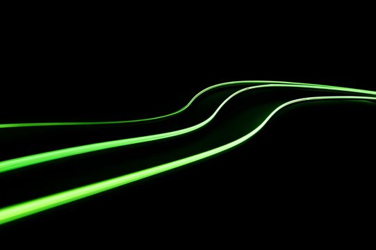 Thin Neon Green Lines Glowing Against Pure Black Background Abstract Minimalist Light Art Modern Design - Powered by Adobe