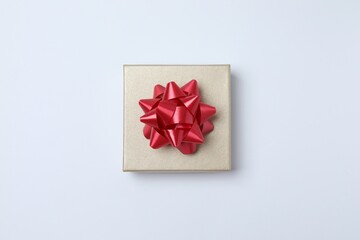 Bright gift box with red bow on white background, Christmas and happy birthday celebration concept