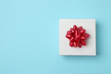 Bright gift box on color surface