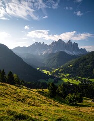 Naklejka premium Vivid landscape of rolling hills and distant, jagged mountain peaks