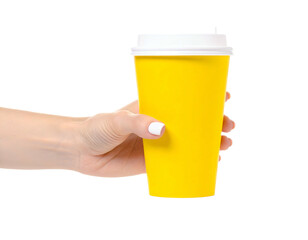 Human hand gripping a yellow paper coffee cup with a white lid, isolated on black background