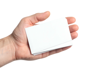 A person's hand holds a small stack of blank, white rectangular cards against a black background
