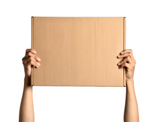 A person's arms hold up a blank cardboard box against a stark, black background