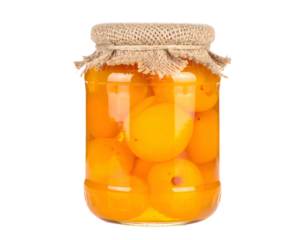 A glass jar filled with preserved peaches, sealed with burlap and filled with syrupy liquid