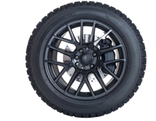 A detailed close-up of a single, dark-colored automotive tire and rim against black