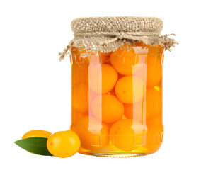 Preserved fruit in a glass jar, with some fruit and leaves