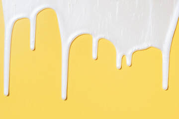 liquid moisturizing shampoo dripping down on yellow background close-up.