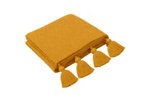 Folded mustard yellow knitted blanket with tassels