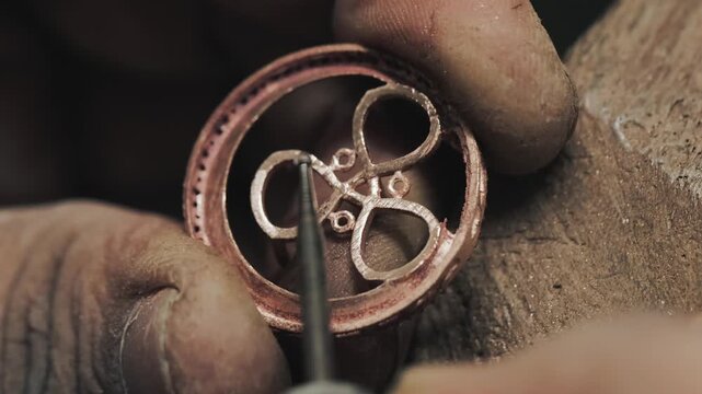 Artisan crafting elegant jewelry with precision &mdash; showcasing the detailed handmade process of designing, shaping, and polishing fine metal ornaments in a workshop.