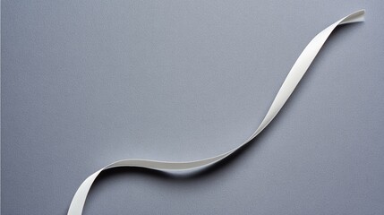 drape. A white ribbon curving downward against a minimalist gray background. wellbeing guides, coaching materials, designed for mental health education and mindfulness programs, clarifies learning.