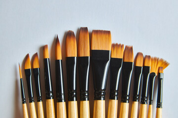 A set of artist's paintbrushes on a white background with copy space.